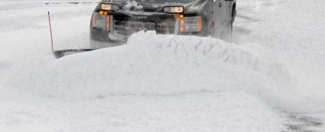 Plow clearing snowy road