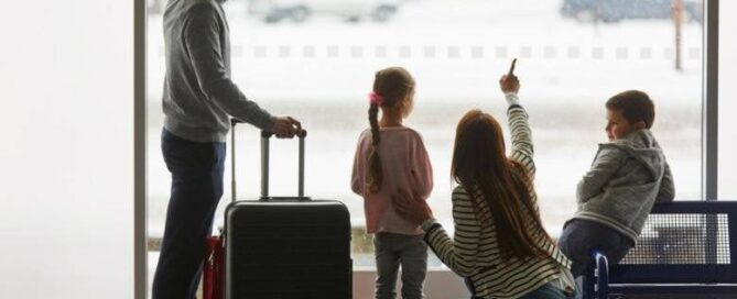 A family at the airport waiting for their departure. Protect your home before you travel with Munn Insurance.