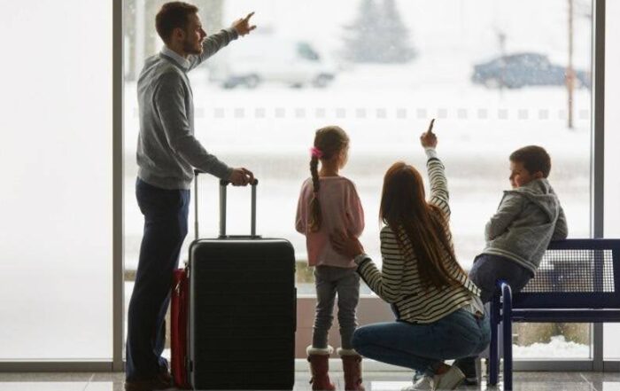 A family at the airport waiting for their departure. Protect your home before you travel with Munn Insurance.